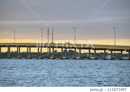 Barron Collier Bridge and Gilchrist Bridge in Florida with moving traffic. Transportation infrastructure in Charlotte County connecting Punta Gorda and Port Charlotte over Peace River 113871997