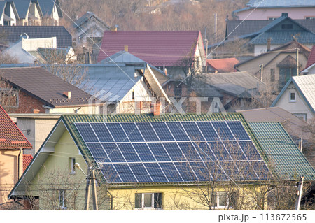 Private home roof covered with solar photovoltaic panels for generating of clean ecological electric energy in suburban rural town area. Concept of autonomous house 113872565