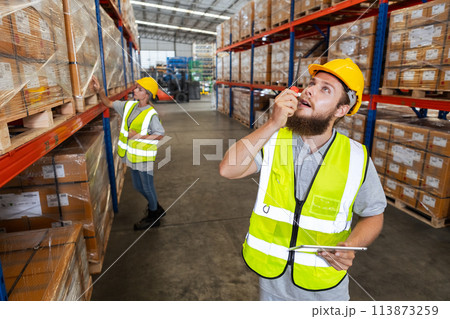 Male holding walkie talkie and tablet quality control standing at machine Male holding walkie talkie and tablet quality control standing at machine 113873259