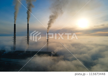 Coal power plant high pipes with black smoke moving upwards polluting atmosphere. Production of electrical energy with fossil fuel concept Coal power plant high pipes with black smoke moving upwards polluting atmosphere. Production of electrical energy with fossil fuel concept 113873448