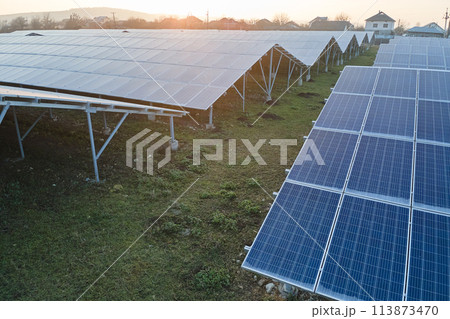 Aerial view of large sustainable electrical power plant with rows of solar photovoltaic panels for producing clean ecological electric energy. Renewable electricity with zero emission concept. 113873470