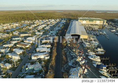 Boat station destroyed by hurricane wind in Florida coastal area. Consequences of natural disaster 113873494