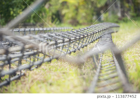 Iron wire reinforcement of concrete work. Construction site objects of bending cutting stainless steel wire fences bar. Civil construction engineering concept. pile of under construction materials 113877452