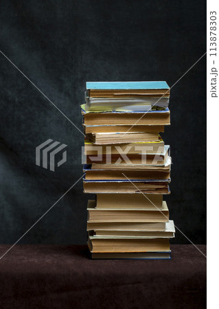 A stack of old books and notebooks on the table A stack of old books and notebooks on the table 113878303