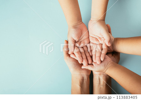 Family top view hands stacked on isolated background. Parents and kid hold empty space expressing support and love for Family and Parents Day. Family top view hands stacked on isolated background. Parents and kid hold empty space expressing support and love for Family and Parents Day. 113883405