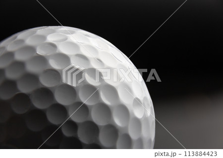 golf ball seen very close. Black background 113884423