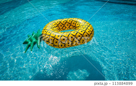 Yellow rubber ring floating in a blue pond on a summer day Yellow rubber ring floating in a blue pond on a summer day 113884899