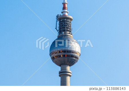 Close-up view of Berlins TV Tower showcasing its spherical observation deck against a clear sky. Berlin, Germany Close-up view of Berlins TV Tower showcasing its spherical observation deck against a clear sky. Berlin, Germany 113886143