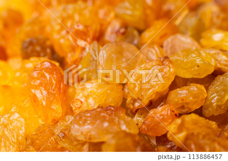 Background of a large number of dried yellow golden grapes. Raisin. Vegetarian diet Background of a large number of dried yellow golden grapes. Raisin. Vegetarian diet 113886457