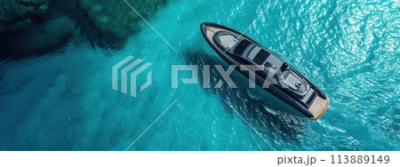 High aerial view of a motor speedboat traveling over blue ocean and leaving a trail of foam and bubbles 113889149