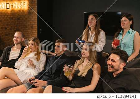 Friends participate in virtual adventures in game room 113894141