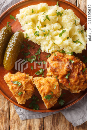 Ground Pork Cheese Schnitzel Czech Holandsky Rizek served with mashed potatoes closeup on the plate on the table. Vertical top view Ground Pork Cheese Schnitzel Czech Holandsky Rizek served with mashed potatoes closeup on the plate on the table. Vertical top view 113895680