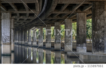 Perspective view of concrete pillars under Khlong Toei Expressway. Perspective view of concrete pillars under Khlong Toei Expressway. 113897081