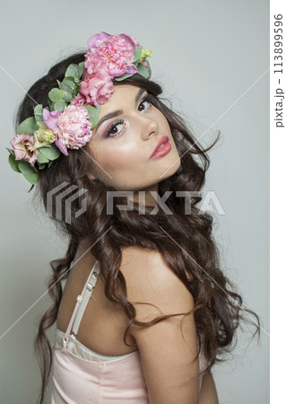 Beautiful healthy woman with clean fresh skin, wavy long hair and flower wreath, beauty portrait Beautiful healthy woman with clean fresh skin, wavy long hair and flower wreath, beauty portrait 113899596
