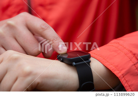 Close-up view of a woman using her smart watch 113899620