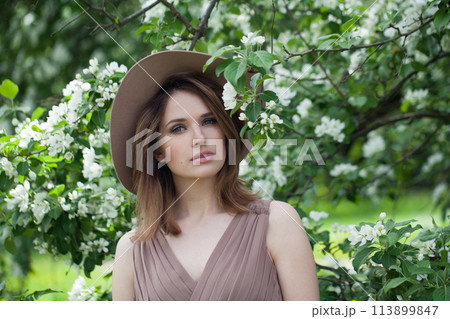 Stylish spring woman enjoying nature outdoor, fashion beauty portrait 113899847