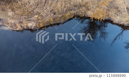 Aerial look down on river blue water surface Aerial look down on river blue water surface 113899890
