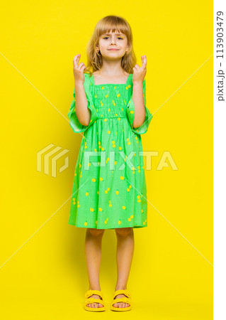 School child girl crossed fingers looking at camera wishing for good luck news game play win victory School child girl crossed fingers looking at camera wishing for good luck news game play win victory 113903479