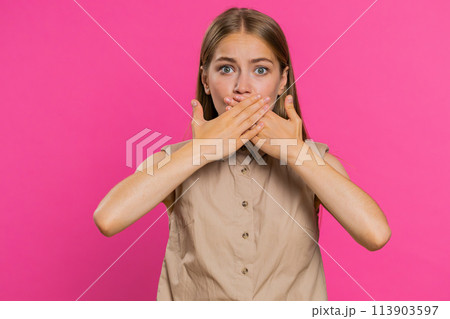Frightened woman closing mouth with hands refusing to tell terrible secret, unbelievable truth Frightened woman closing mouth with hands refusing to tell terrible secret, unbelievable truth 113903597
