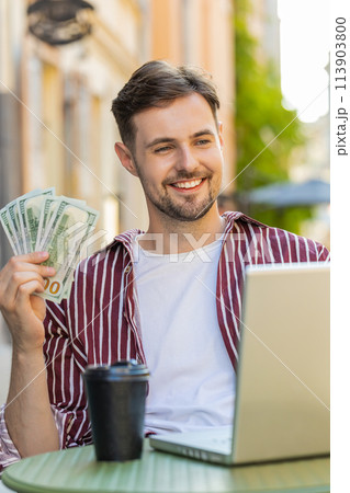 Happy rich man counting money dollar cash menu app ordering food, delivery online in city cafeteria 113903800