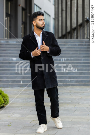 Strict business man looks to the side dreaming resting, good news feel satisfied stay in city street 113904447