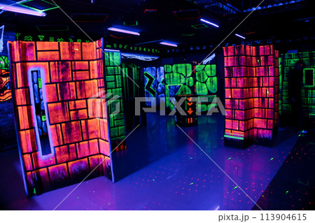Labyrinth in neon light. Laser tag, paintball in the maze Labyrinth in neon light. Laser tag, paintball in the maze 113904615