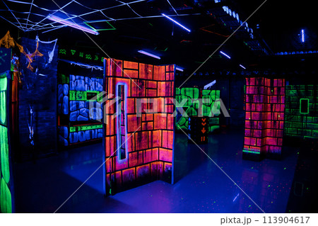 Labyrinth in neon light. Laser tag, paintball in the maze Labyrinth in neon light. Laser tag, paintball in the maze 113904617