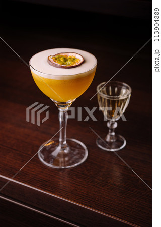 Elegant passion fruit cocktail with shot glass Elegant passion fruit cocktail with shot glass 113904889