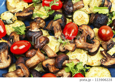 Baked seasonal vegetables with herbs. 113906228