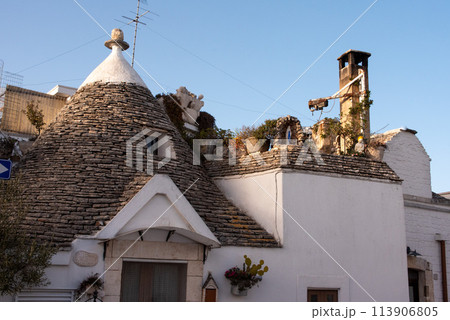 Scenic roofs of houses in historic Trulli district in Alberobello, Italy 113906805