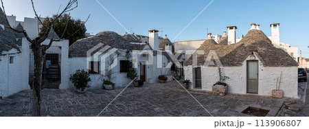 Scenic roofs of houses in historic Trulli district in Alberobello, Italy 113906807