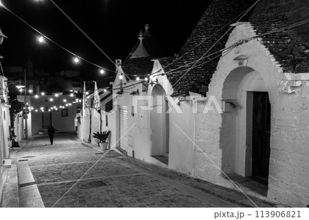Scenic abandoned street in the Trulli district of Alberobello, Italy 113906821
