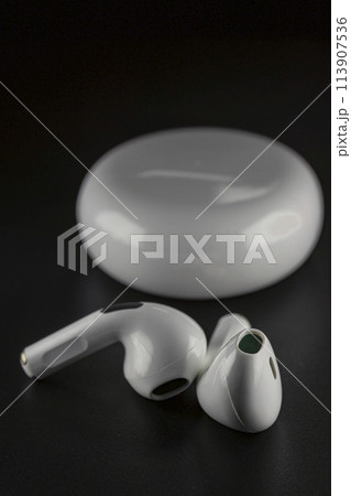 ROSTOV-ON-DON, RUSSIA - APRIL 28, 2018: Apple AirPods wireless Bluetooth headphones and charging case for Apple iPhone. New Apple Earpods Airpods in box. ROSTOV-ON-DON, RUSSIA - APRIL 28, 2018: Apple AirPods wireless Bluetooth headphones and charging case for Apple iPhone. New Apple Earpods Airpods in box. 113907536
