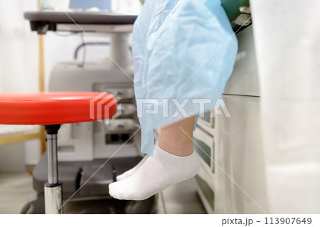 A young woman at a mammologist's appointment for examination of mammary glands and lymph nodes. Patient waiting of gynecological ultrasound exam. 113907649