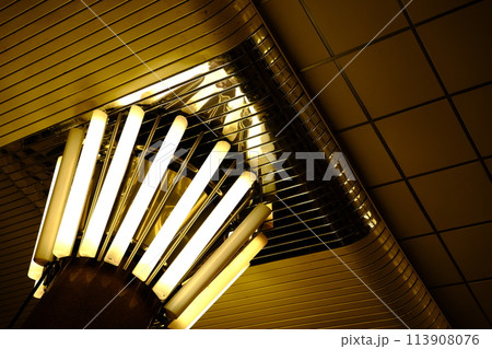 Lamps in subway kyiv Yellow light with reflections on metal parts of interior 113908076