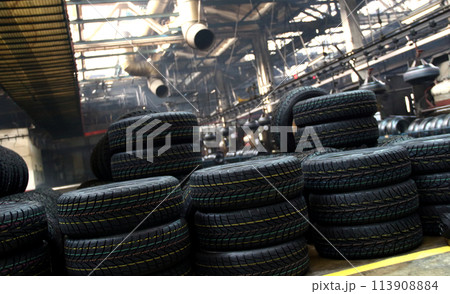 Tires production plant site. New cars tires stacking up on the workshop floor  113908884