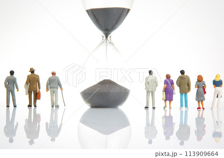miniature people. group of different people stand near an hourglass against a white background miniature people. group of different people stand near an hourglass against a white background 113909664