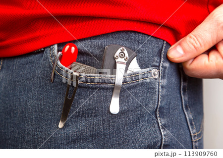 Pen, knife and flashlight with clips in your jeans pocket. EDC items 113909760