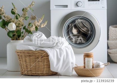 Basket full of white dirty towels for washing on blurred background of washing machine in bathroom. Concept allergy and chore. Close up. Basket full of white dirty towels for washing on blurred background of washing machine in bathroom. Concept allergy and chore. Close up. 113910239