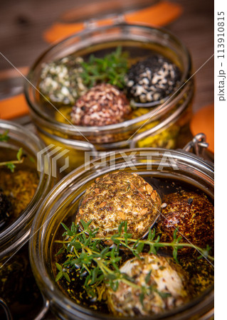 LABNEH CHEESE BOLLS WITH DRY MINT, BLACK AND WHITE SESAME, SUMAC AND ZAATAR IN A JAR WITH OLIVE OIL 113910815