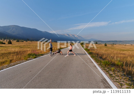 Diverse Athletes Prepare: Dynamic Group Warms Up for Morning Run. 113911133