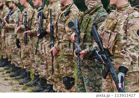 Soldier fighters standing together with guns. Group portrait of US army elite members, private military company servicemen, anti terrorist squad 113911427