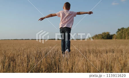 boy child running across field playing airplane flight dream, creative child play, escape game outdoor, child's dream fligh, kid fun running, imaginative child play, field freedom boy, dream game run 113911620