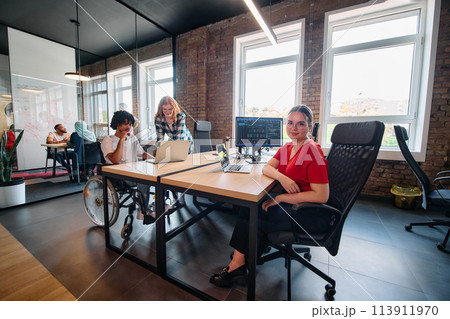 A diverse group of business professionals collaborates in a modern startup coworking center, utilizing a mix of paper-based and technological tools such as mobile phones and computers A diverse group of business professionals collaborates in a modern startup coworking center, utilizing a mix of paper-based and technological tools such as mobile phones and computers 113911970