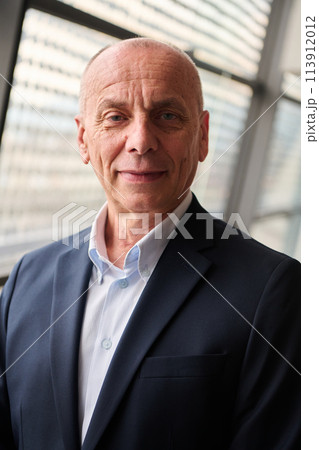 Portrait of an Experienced Businessman in Modern Conference Setting Portrait of an Experienced Businessman in Modern Conference Setting 113912012