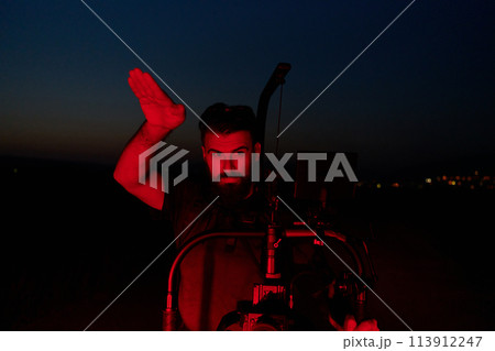 Nighttime Capture: Professional Videographer Films Athletes Running in Red-Lit Darkness Nighttime Capture: Professional Videographer Films Athletes Running in Red-Lit Darkness 113912247