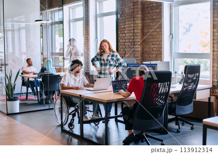 A diverse group of business professionals collaborates in a modern startup coworking center, utilizing a mix of paper-based and technological tools such as mobile phones and computers A diverse group of business professionals collaborates in a modern startup coworking center, utilizing a mix of paper-based and technological tools such as mobile phones and computers 113912314