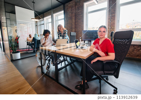 A diverse group of business professionals collaborates in a modern startup coworking center, utilizing a mix of paper-based and technological tools such as mobile phones and computers A diverse group of business professionals collaborates in a modern startup coworking center, utilizing a mix of paper-based and technological tools such as mobile phones and computers 113912639