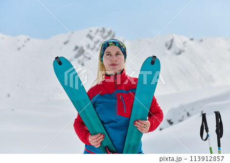 Conquering the Peak: Confident Skier Celebrates Success Conquering the Peak: Confident Skier Celebrates Success 113912857