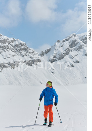 A Skier Scales a Treacherous Alpine Peak A Skier Scales a Treacherous Alpine Peak 113913048